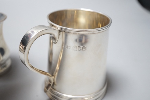 A George V silver christening mug, Goldsmiths & Silversmiths Co. Ltd, London, 1915, 85mm and a smaller Scottish silver christening mug, 9oz.